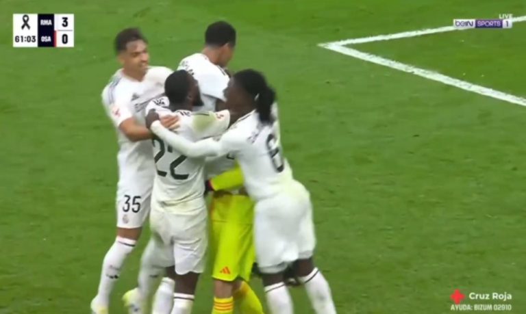 Real Madrid players go to celebrate with goalkeeper Lunin after he assisted Vinícius Júnior with a brilliant goal